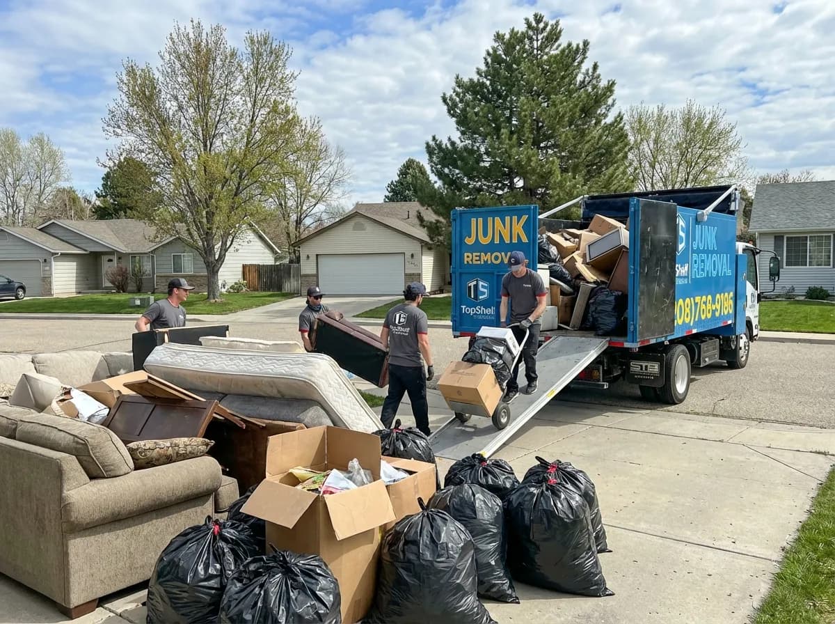 Top Shelf crew member loading bulk trash into the junk removal truck in Boise Idaho