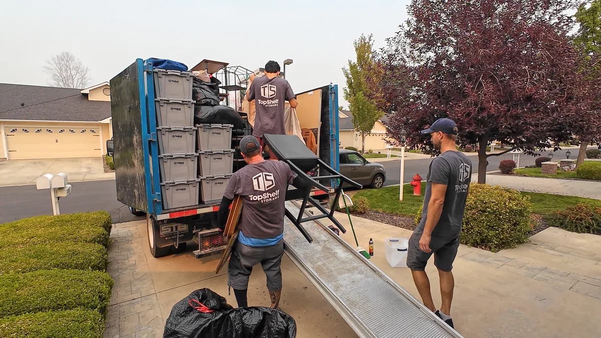Top Shelf crew loading a truck with furniture and bins during an estate cleanout in Nampa, Idaho