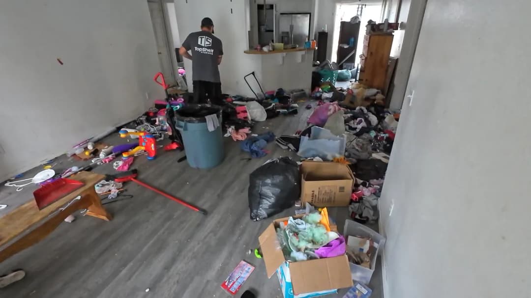 Top Shelf crew member clearing out a hoarded living room filled with household items in Meridian Idaho