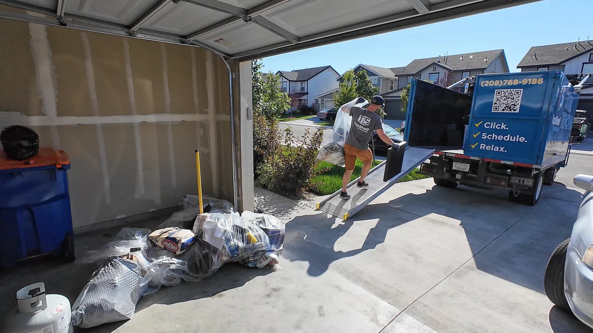 Top Shelf crew loading items from a garage during a house cleanout in Meridian Idaho