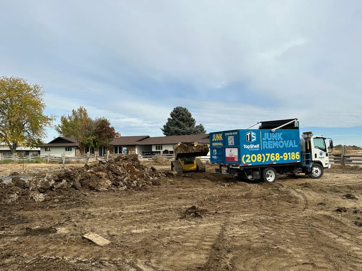 Top Shelf skid steer loading manure for removal