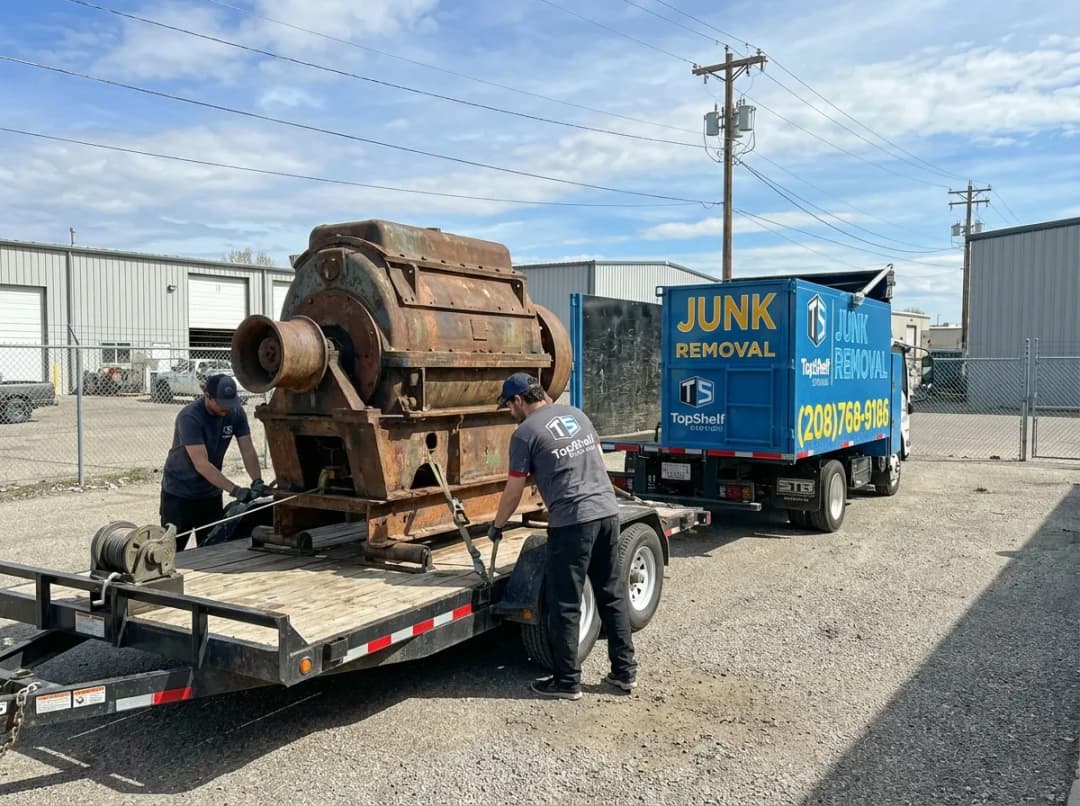 Top Shelf crew removing industrial equipment from a residential property in Kuna Idaho