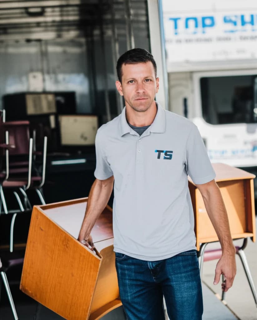 Professional team removing old desks and furniture from school classroom in Boise Idaho
