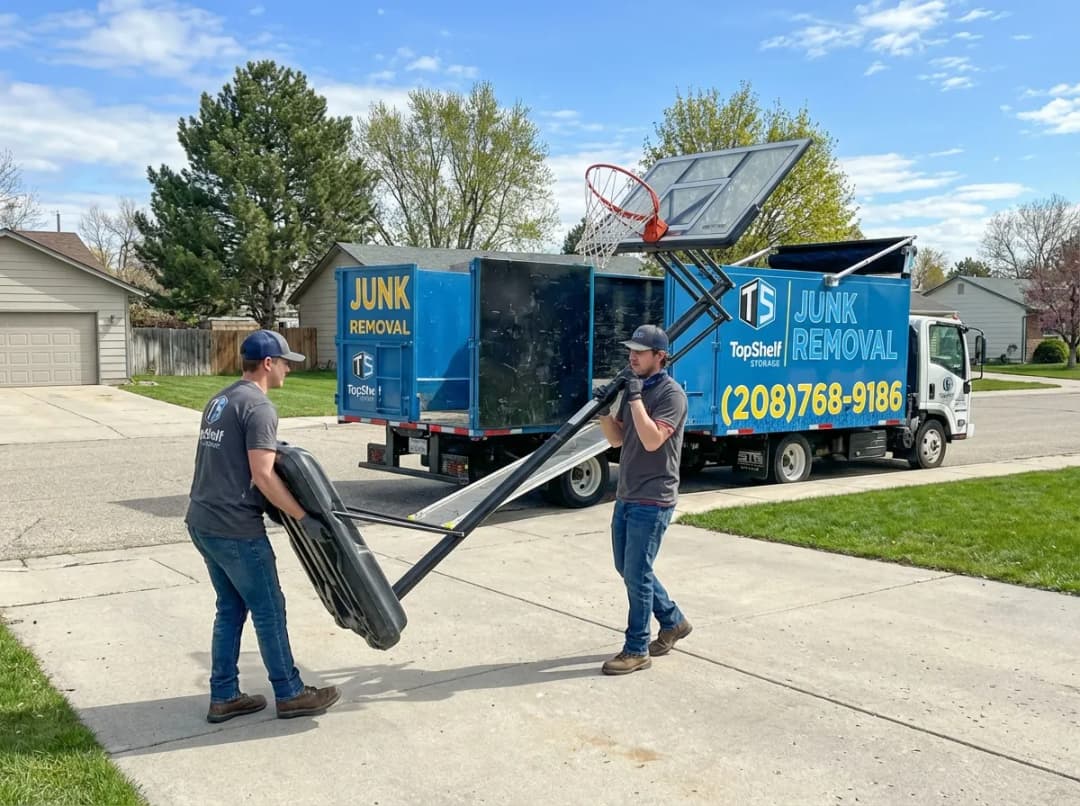 Top Shelf crew removing a basketball hoop from a residential property in Kuna Idaho