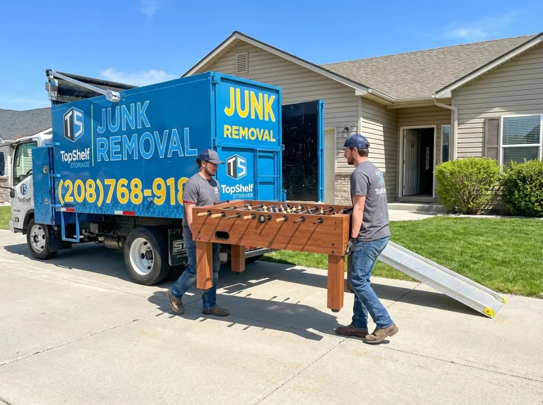 Top Shelf crew removing a foosball table from a game room in Garden City Idaho
