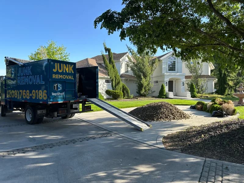 Top Shelf branded truck loaded with bushes during yard debris removal in Eagle Idaho