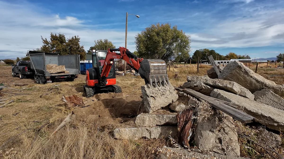 Top Shelf excavator removing concrete at a rural property