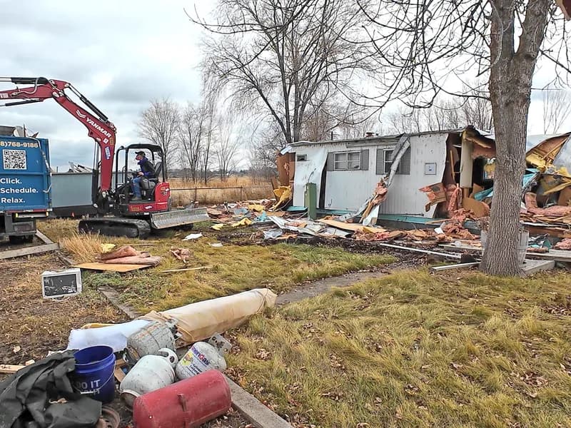 Top Shelf crew using an excavator to tear down an old manufactured home for demolition in Karcher, Nampa, Idaho