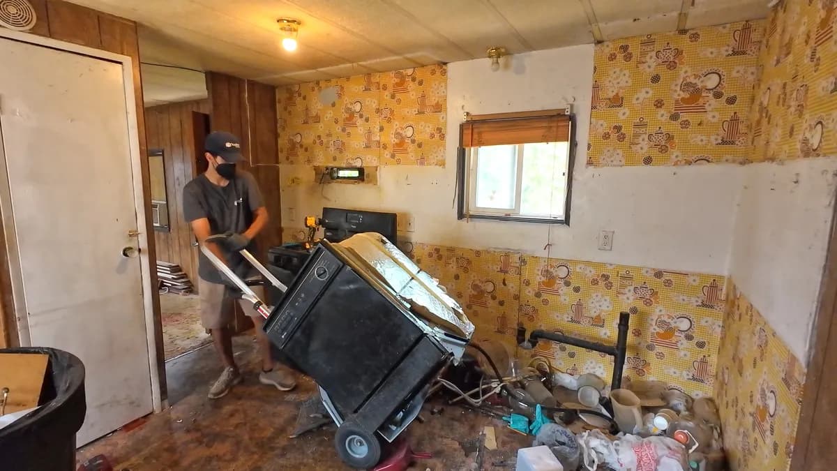 Top Shelf crew member removing an old dishwasher from a kitchen in Meridian Idaho