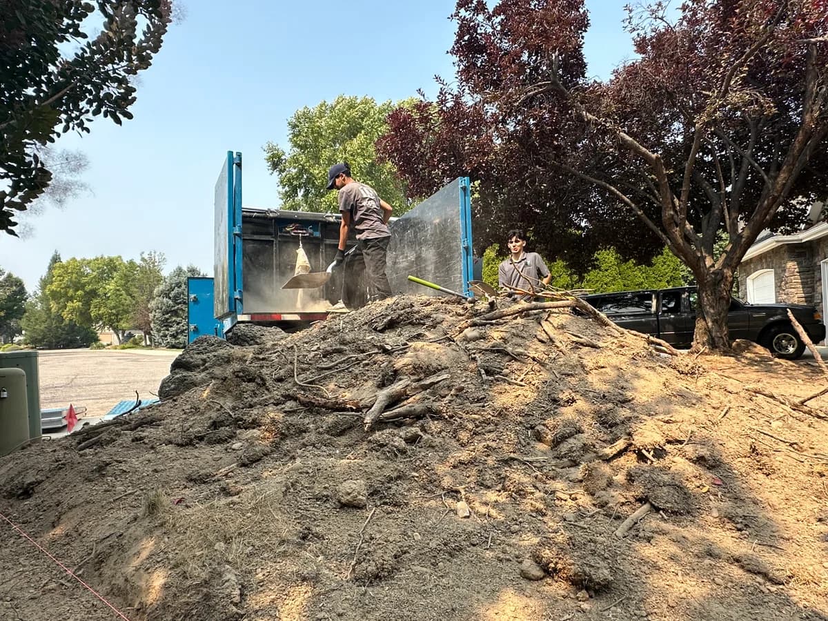 Top Shelf crew shoveling dirt during a bulk material removal job in Emmett Idaho