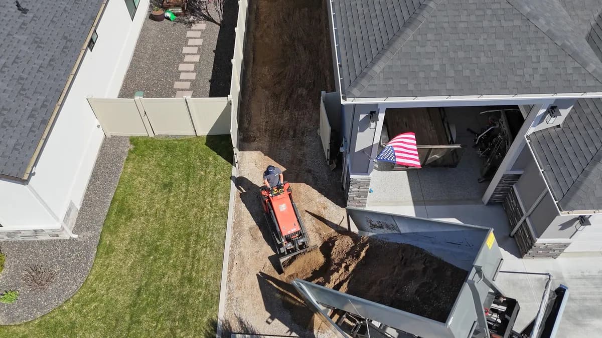 Aerial view of Top Shelf skid steer loading dirt for removal in Middleton Idaho