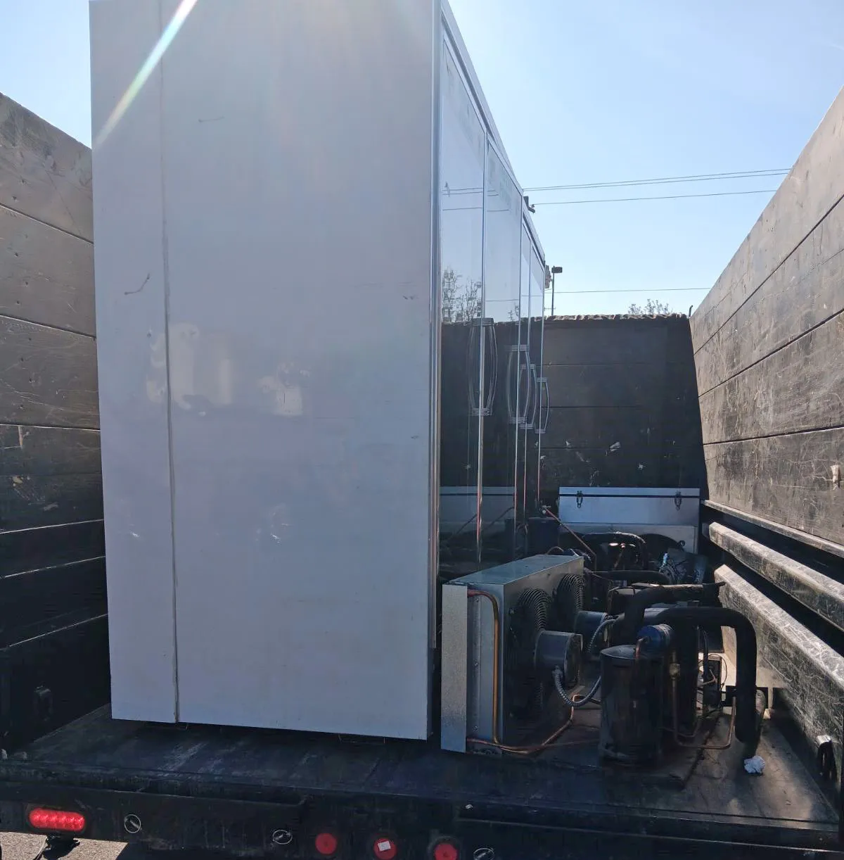 Walk-in cooler compressor loaded on Top Shelf truck after commercial removal in Garden City Idaho