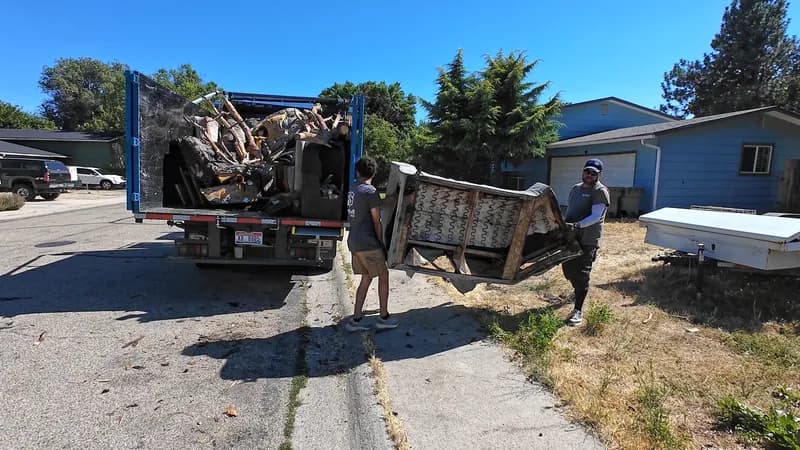 Top Shelf crew loading a couch frame into the truck at a residential property in Eagle Idaho