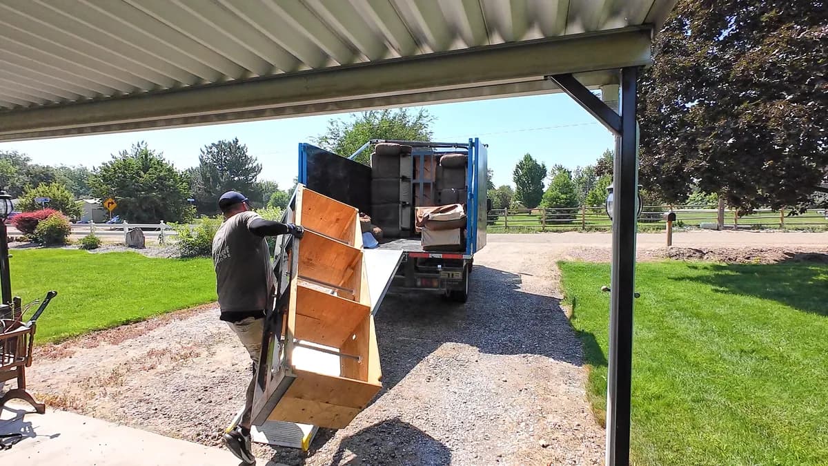 Top Shelf crew loading a dresser from under a carport into the truck in Eagle Idaho