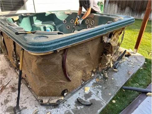 Top Shelf crew demolishing and removing a hot tub from a backyard in Eagle Idaho
