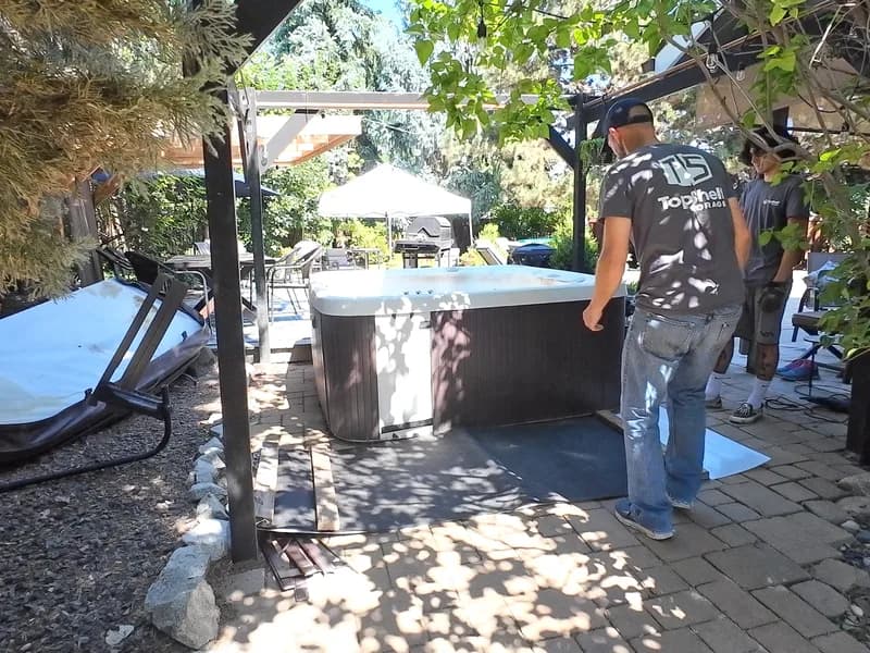 Top Shelf crew assessing a hot tub removal on a backyard patio in Indian Creek, Caldwell, Idaho