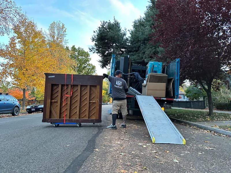 Top Shelf crew guiding a piano up the truck ramp in Nampa Idaho