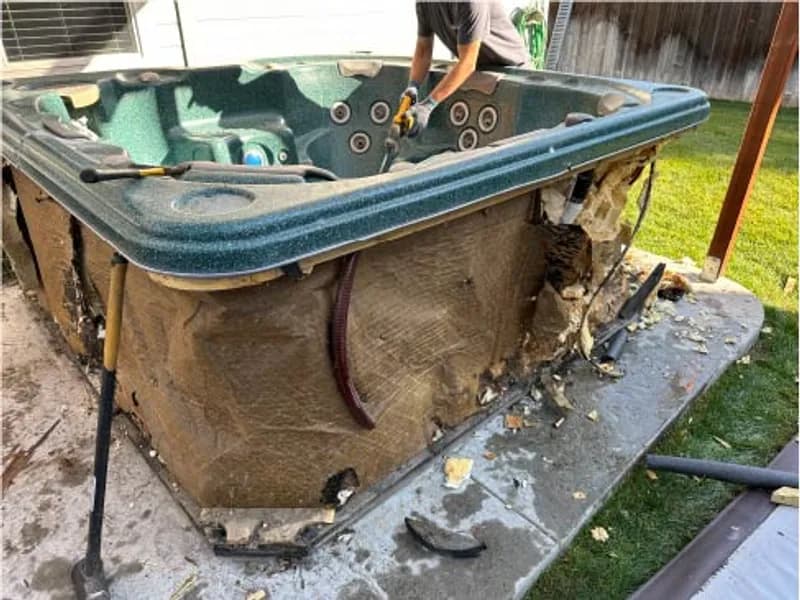 Hot tub being dismantled and removed from backyard in Eagle, Idaho