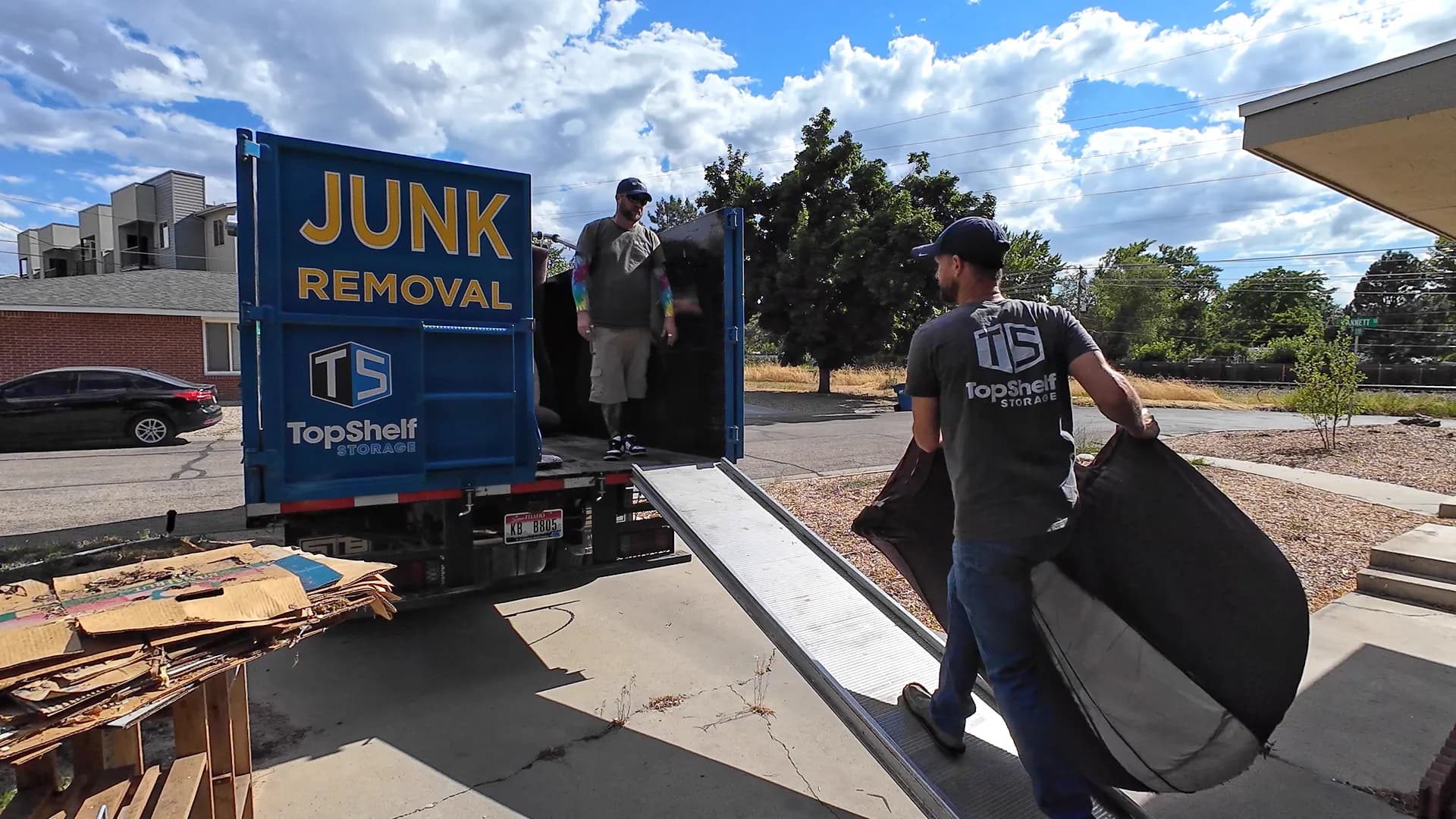 Top Shelf crew picking up a couch and cardboard boxes curbside in Boise Idaho