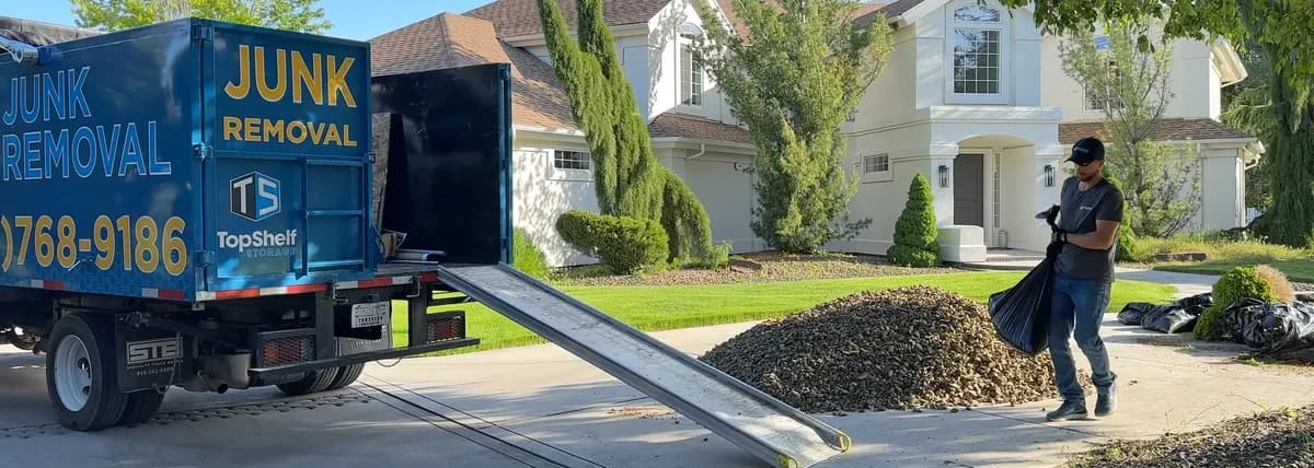 Bags of rock being loaded onto the Top Shelf branded truck at a residential property in Middleton Idaho
